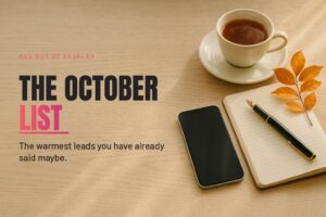 A phone, an open notebook and a cup of tea on a kitchen table in soft October morning light.